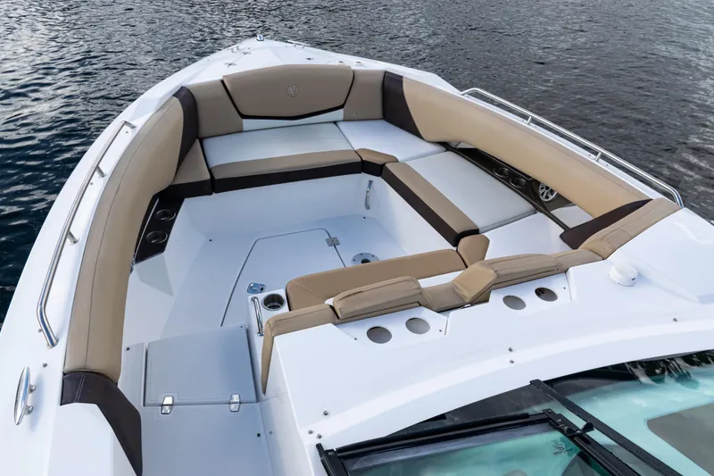 Slide: The Image of 2015 Cruisers Yachts 338 Bow Rider interior with beige seating and cup holders. - 9