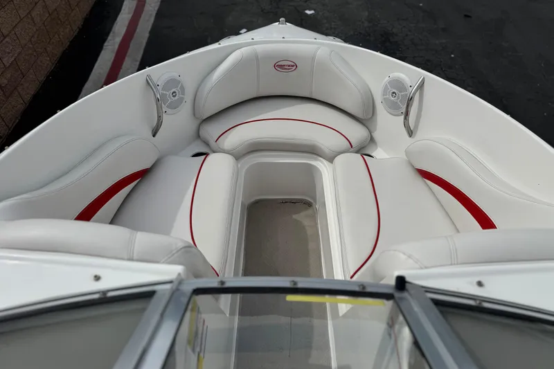 Slide: The Image of 2007 Ebbtide 180 SE boat interior with white and red seating, featuring speakers. - 10