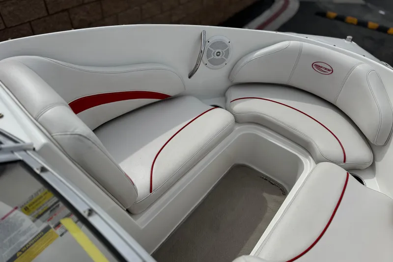 Slide: The Image of 2007 Ebbtide 180 SE boat interior with white and red cushioned seating. - 11