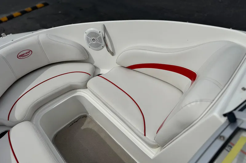 Slide: The Image of 2007 Ebbtide 180 SE boat interior with white and red cushioned seating. - 12