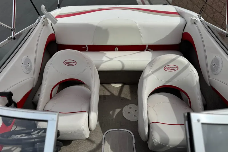 Slide: The Image of 2007 Ebbtide 180 SE boat interior with white and red seating, steering wheel visible. - 13