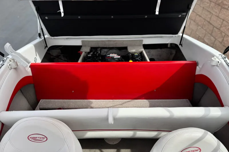 Slide: The Image of 2007 Ebbtide 180 SE boat interior with open engine compartment and red panel. - 14