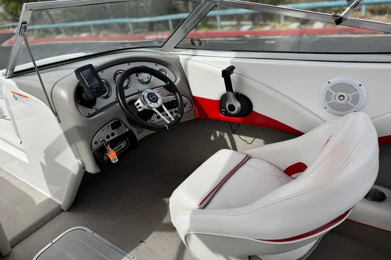 Slide: The Image of 2007 Ebbtide 180 SE boat interior with steering wheel and dashboard controls. - 21