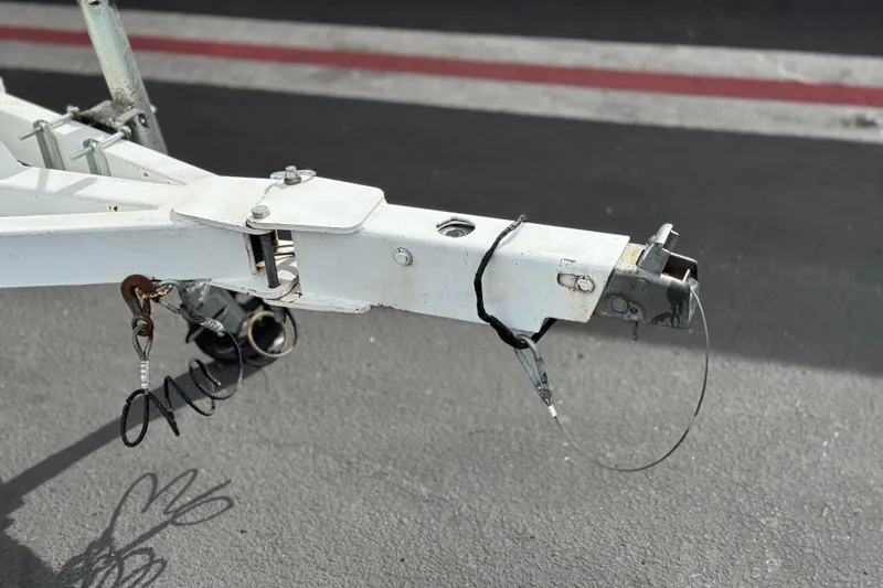 Slide: The Image of Trailer hitch of a 2007 Ebbtide 180 SE boat on asphalt surface. - 25