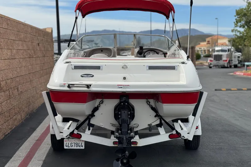 Slide: The Image of 2007 Ebbtide 180 SE boat with red canopy on trailer, parked outdoors. - 4
