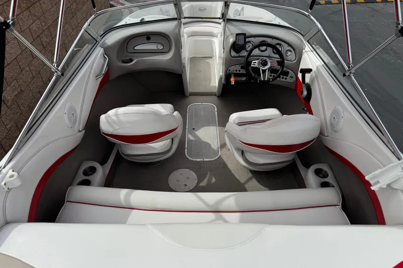Slide: The Image of 2007 Ebbtide 180 SE boat interior with white and red seating, steering wheel, and dashboard. - 8