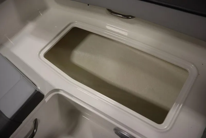 Slide: The Image of 2024 Bayliner 2050 DX boat storage compartment, white interior with handles. - 20
