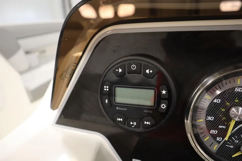 Slide: The Image of Dashboard controls of 2024 Bayliner 2050 DX boat, featuring speedometer and digital display. - 24