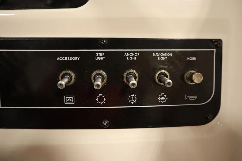 Slide: The Image of Control panel of 2024 Bayliner 2050 DX boat with labeled switches. - 27