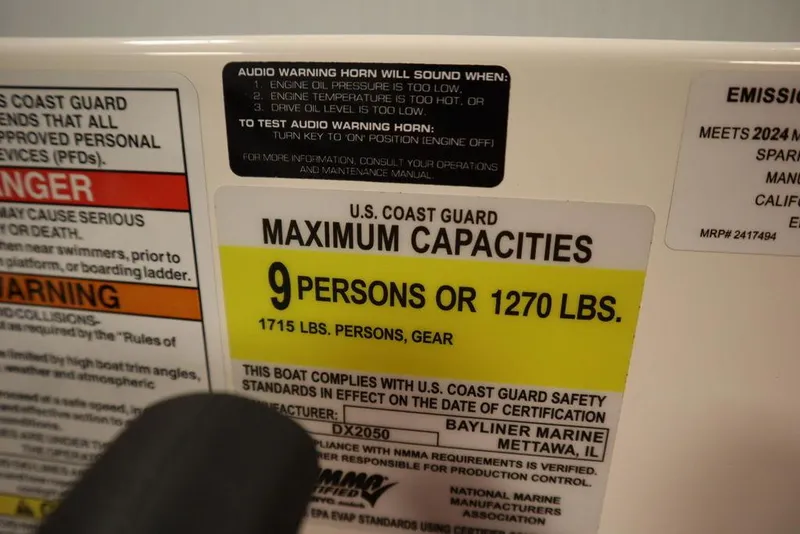 Slide: The Image of Bayliner 2050 DX 2024 capacity label: 9 persons or 1270 lbs. - 29