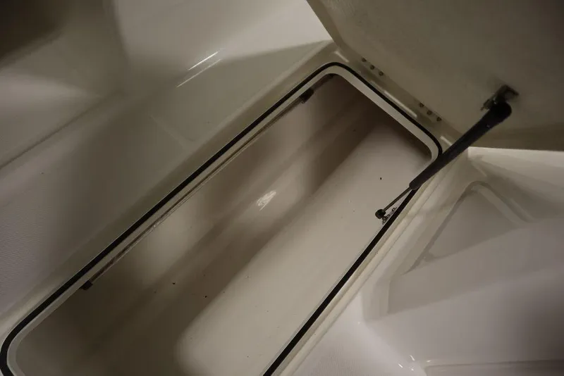 Slide: The Image of Open storage compartment in 2024 Bayliner 2050 DX boat. - 33