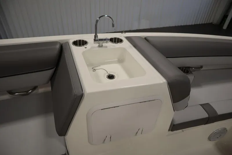 Slide: The Image of 2024 Bayliner 2050 DX boat interior with sink and seating area. - 34