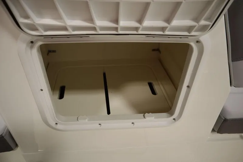 Slide: The Image of Open storage compartment in 2024 Bayliner 2050 DX boat. - 35