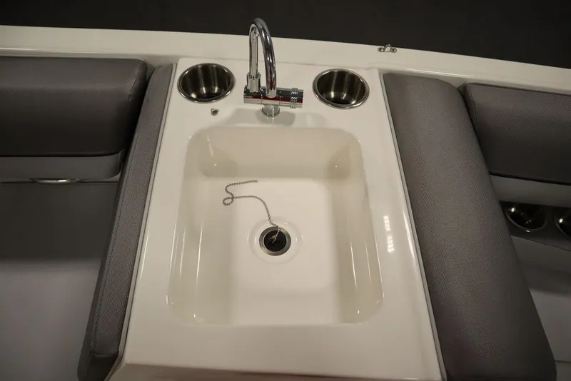 Slide: The Image of 2024 Bayliner 2050 DX boat interior with sink and cup holders. - 36
