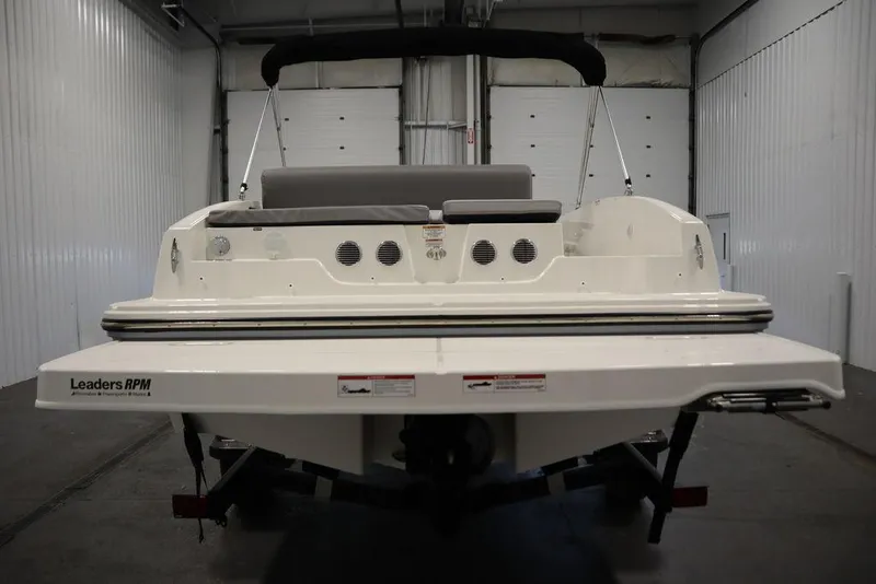 Slide: The Image of 2024 Bayliner 2050 DX boat in a storage facility, rear view. - 6