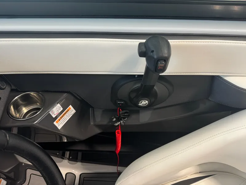Slide: The Image of Interior view of 2018 Monterey 258 Super Sport boat controls and cup holder. - 16