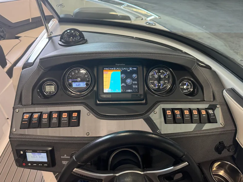 Slide: The Image of Dashboard of a 2018 Monterey 258 Super Sport boat with navigation and control panels. - 19