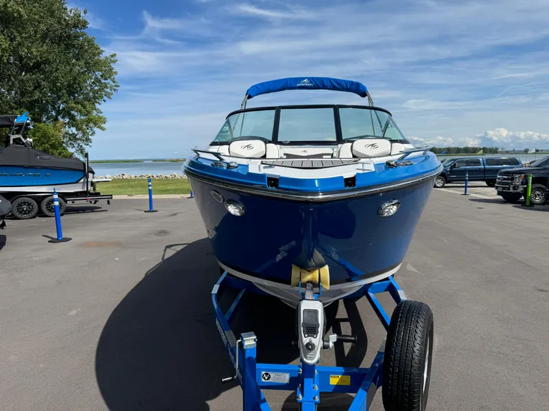 Slide: The Image of 2018 Monterey 258 Super Sport boat on trailer, parked near a scenic waterfront. - 2