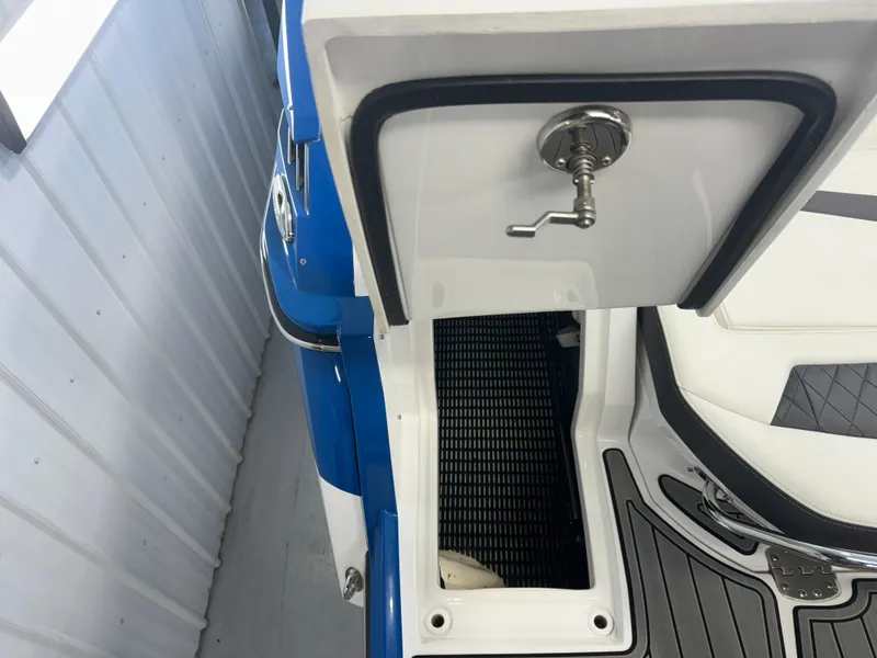 Slide: The Image of 2018 Monterey 258 Super Sport boat interior with open storage compartment and faucet. - 22