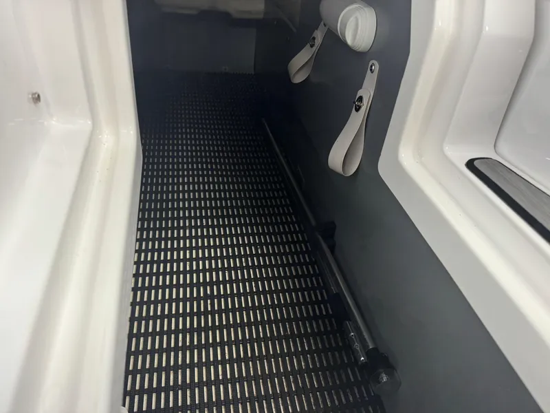 Slide: The Image of Interior view of a 2018 Monterey 258 Super Sport boat with black flooring. - 23