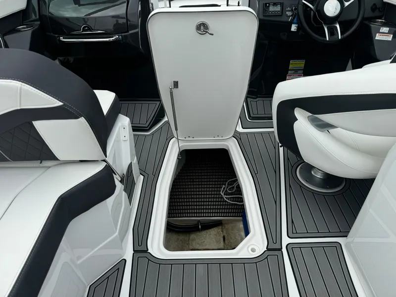 Slide: The Image of Interior of 2018 Monterey 258 Super Sport boat with open storage compartment. - 39