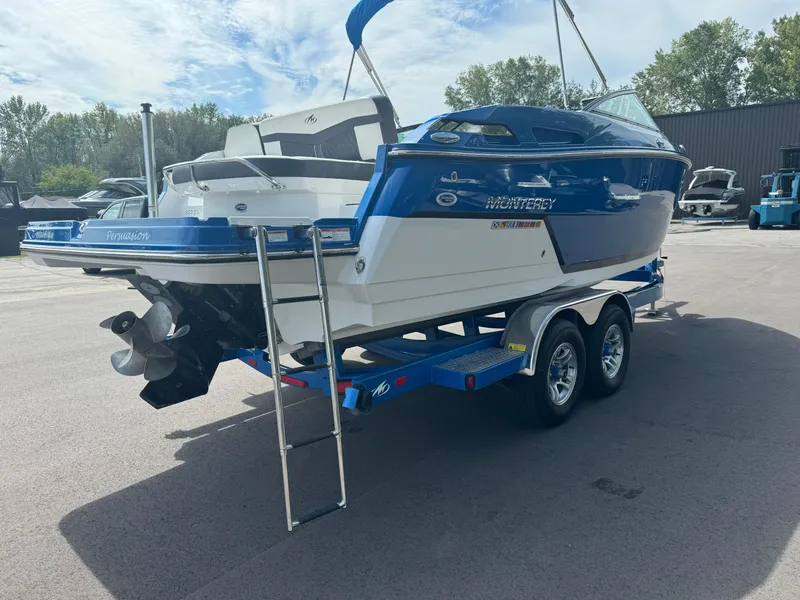 Slide: The Image of 2018 Monterey 258 Super Sport boat on trailer, blue and white, parked outdoors. - 4