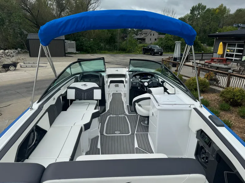 Slide: The Image of 2018 Monterey 258 Super Sport boat with blue canopy and sleek interior design. - 7