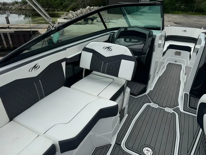 Slide: The Image of 2018 Monterey 258 Super Sport boat interior with sleek black and white seating and modern design. - 8