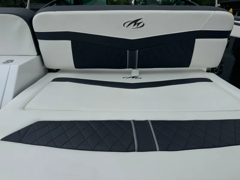 Slide: The Image of 2018 Monterey 258 Super Sport boat interior with black and white cushioned seating. - 9