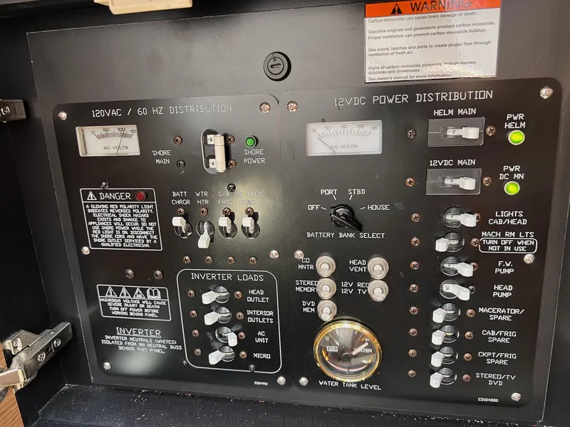Slide: The Image of Control panel of a 2019 Cruisers Yachts 338 IO, featuring power distribution and inverter loads. - 34