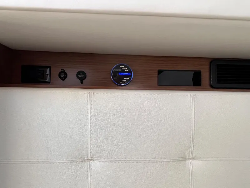 Slide: The Image of 2019 Cruisers Yachts 338 IO interior panel with controls and outlets. - 38