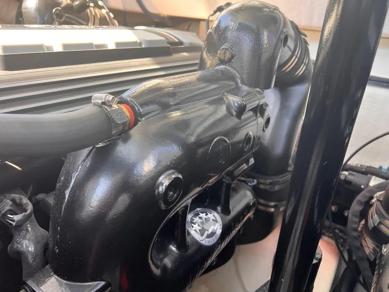 Slide: The Image of Engine compartment of a 2019 Cruisers Yachts 338 Bow Rider, showcasing black components. - 46