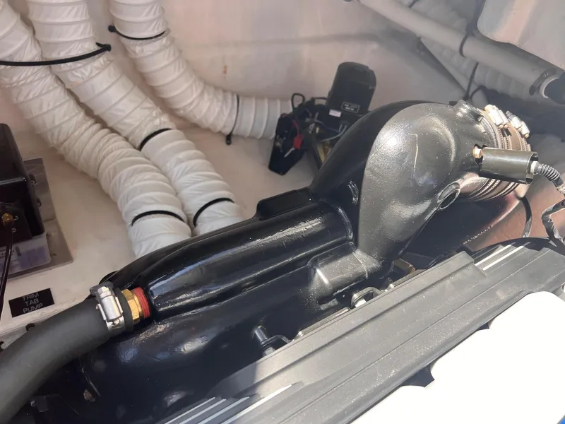 Slide: The Image of Engine compartment of 2019 Cruisers Yachts 338 Bow Rider with visible hoses and components. - 50