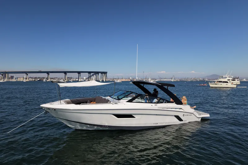 The Image of 2019 Cruisers Yachts 338 Bow Rider on water, bridge and boats in background. - 0