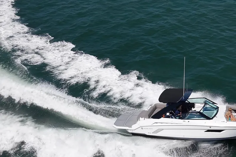 Slide: The Image of 2019 Cruisers Yachts 338 Bow Rider speeding on open water, creating a dynamic wake. - 69