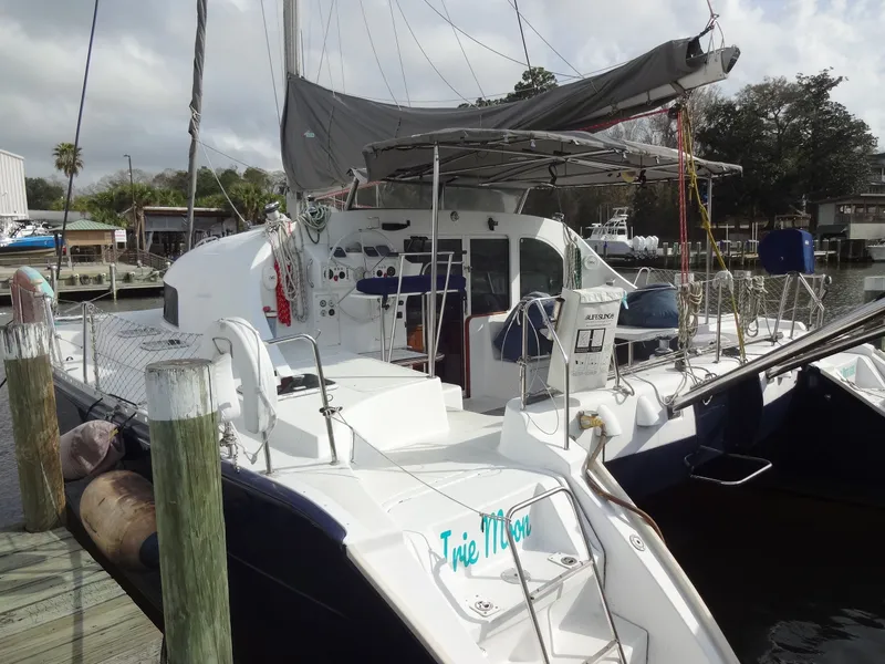 Slide: The Image of 2003 Lagoon 410 catamaran docked at marina. - 11