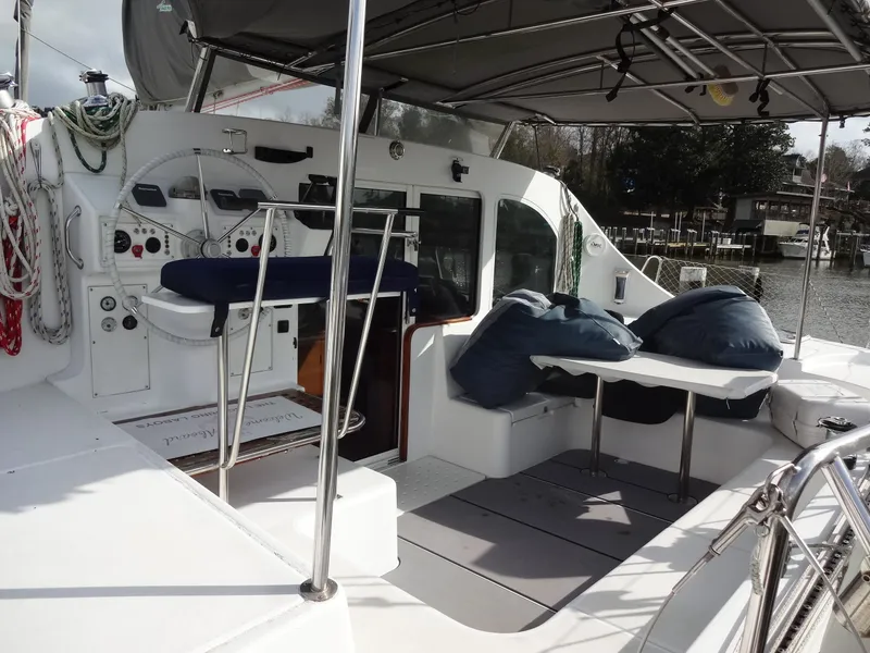 Slide: The Image of Interior of a 2003 Lagoon 410 yacht with helm and seating area. - 12