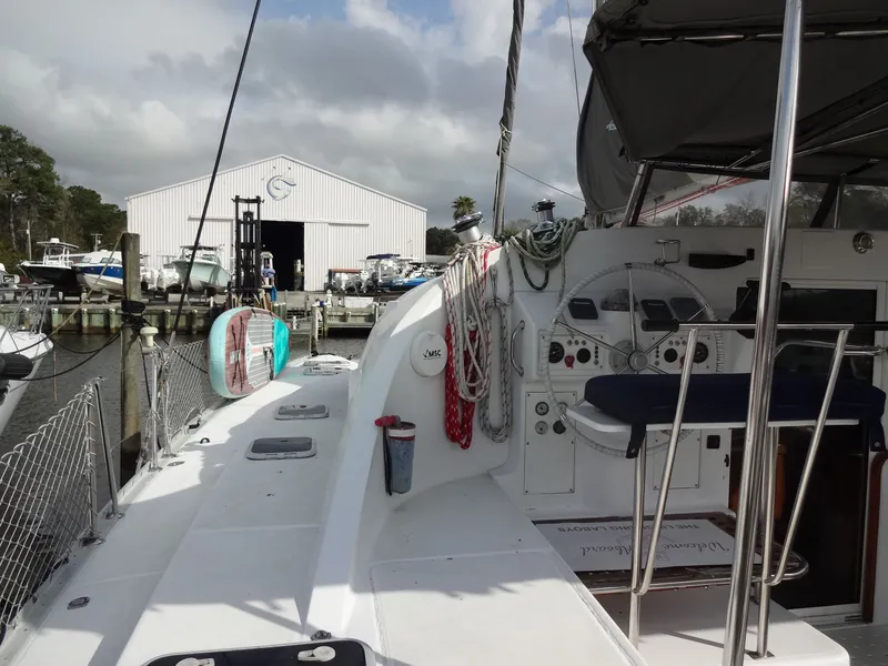 Slide: The Image of 2003 Lagoon 410 catamaran docked with steering wheel view. - 13
