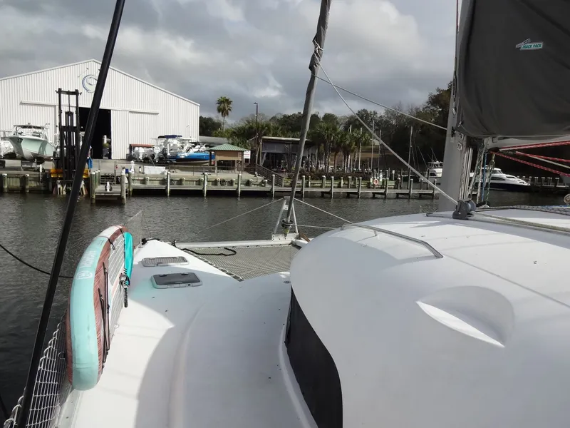 Slide: The Image of 2003 Lagoon 410 catamaran docked at marina. - 14