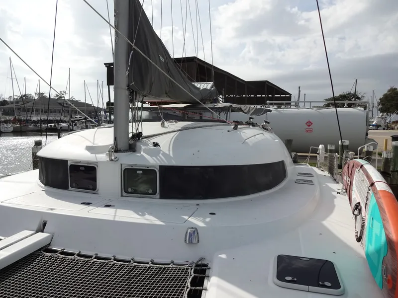 Slide: The Image of 2003 Lagoon 410 catamaran docked at marina. - 15