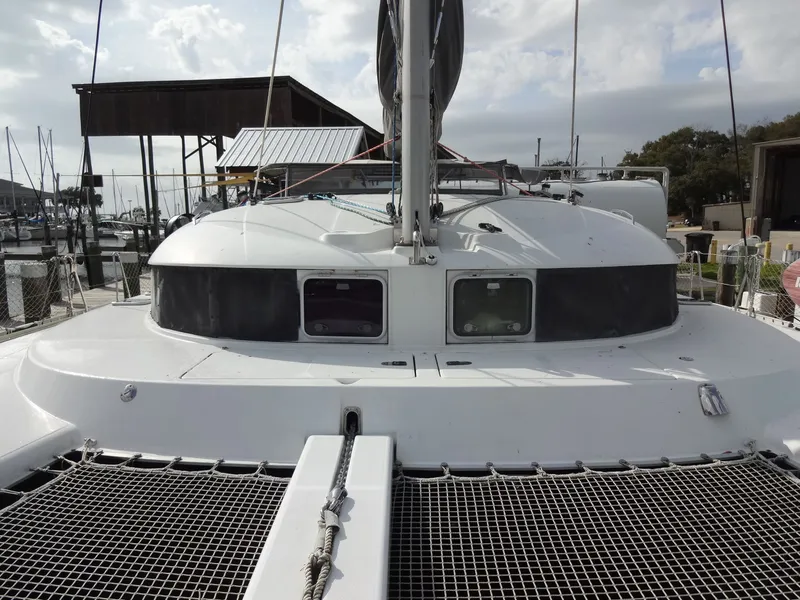 Slide: The Image of 2003 Lagoon 410 catamaran docked at marina. - 16