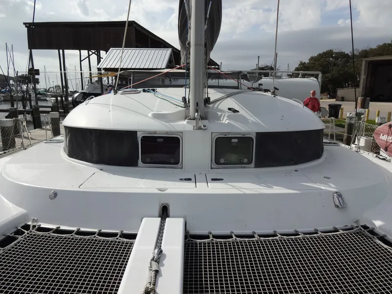 Slide: The Image of 2003 Lagoon 410 catamaran docked at marina. - 17