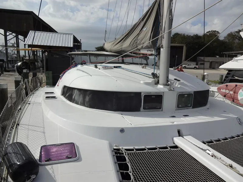 Slide: The Image of 2003 Lagoon 410 catamaran docked at harbor. - 18