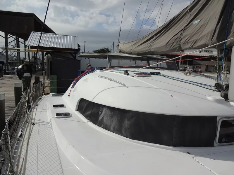 Slide: The Image of 2003 Lagoon 410 catamaran docked at harbor. - 19