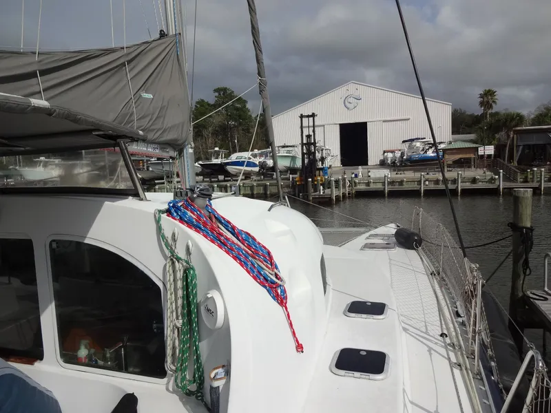 Slide: The Image of 2003 Lagoon 410 catamaran docked with shipyard in background. - 20