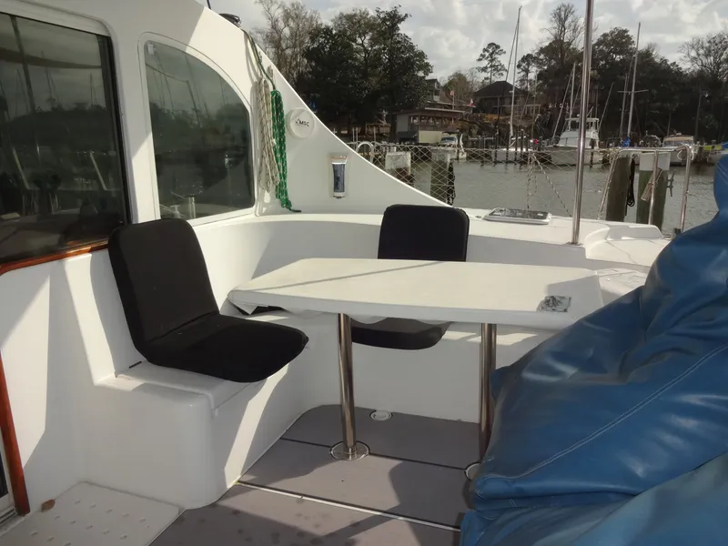 Slide: The Image of Lagoon 410 catamaran cockpit with table and chairs, year 2003. - 22