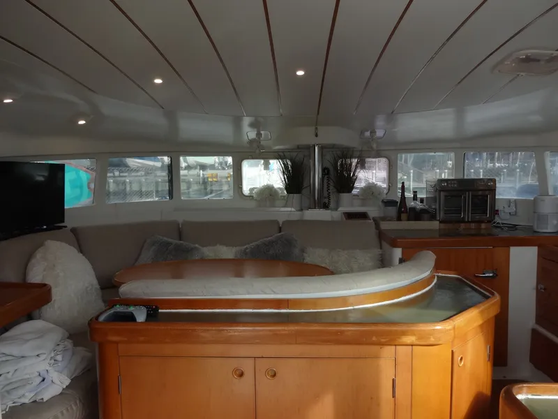 Slide: The Image of Interior of a 2003 Lagoon 410 yacht with cozy seating area. - 29