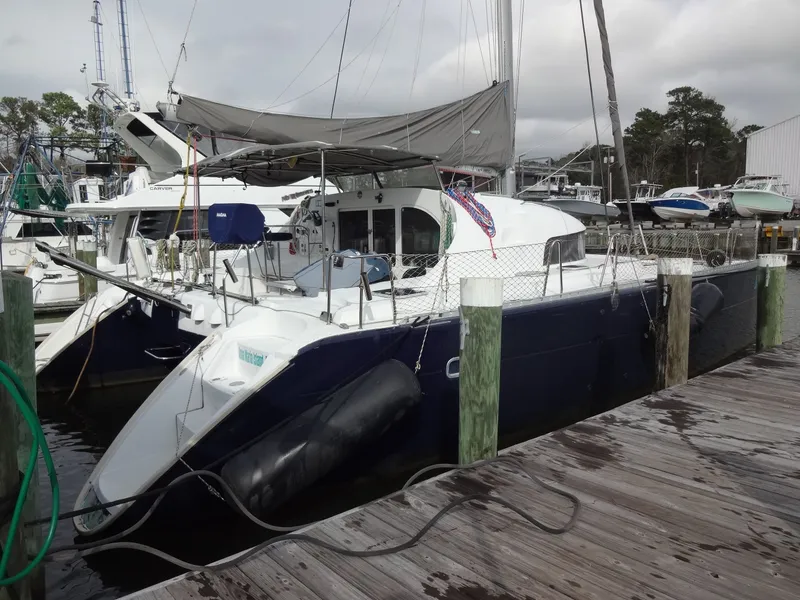 Slide: The Image of 2003 Lagoon 410 catamaran docked at marina. - 7