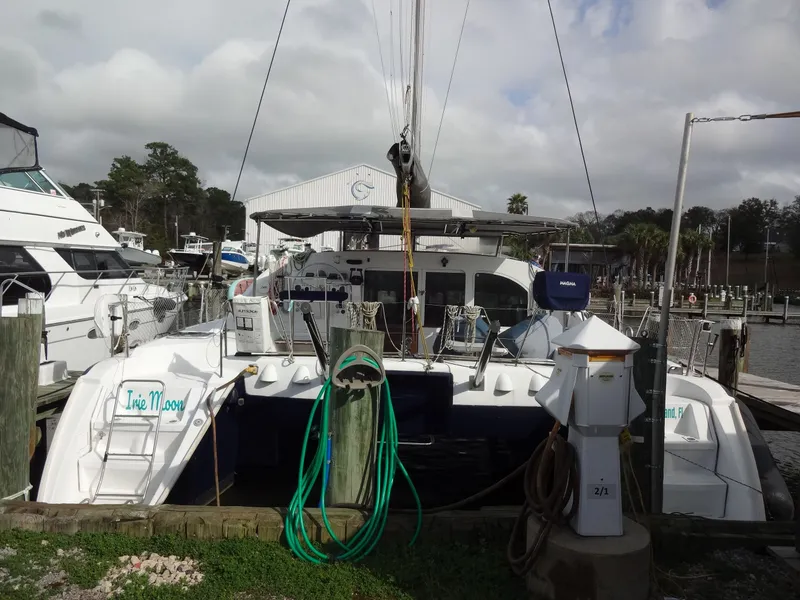 Slide: The Image of 2003 Lagoon 410 catamaran docked at marina. - 8