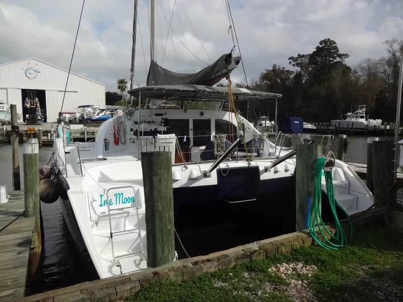 Slide: The Image of 2003 Lagoon 410 catamaran docked at marina. - 9